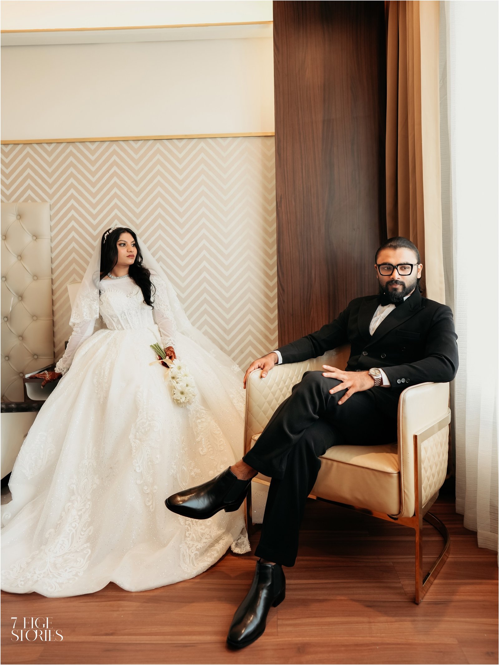 Bride and groom seated together for a wedding portrait